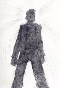 This is a picture of Mickey Laddow's silhouette, viewed from below. He is backlit, so his features and clothing are almost totally black. He stands with his legs slightly apart. His hands are loose fists, hanging below his waist. He looks off to one side, as if trying to see something in distance.